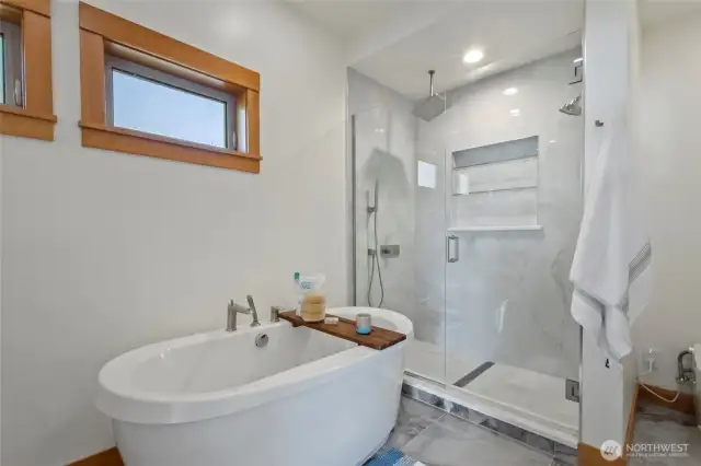Renovated primary bathroom with a deep soaker tub