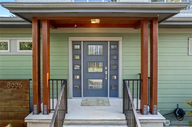 Front door and porch leading to an additional door to access the mudroom/pantry/kitchen
