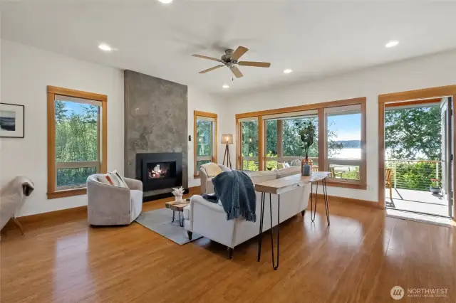 Living room includes a fireplace overlooking the patio with water views