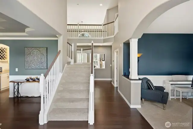 Grand entry with soaring ceilings and dual staircase!  Newly refinished hardwood floors and lush, new upgraded carpet and paint throughout!