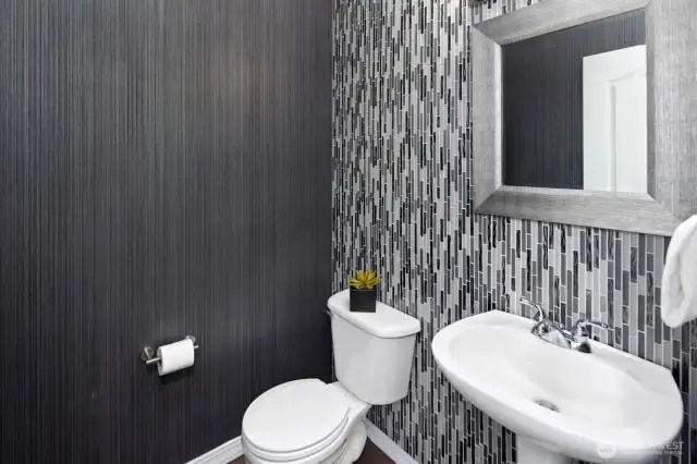 Downstairs powder room with custom tile and designer wallpaper.  Beautiful!
