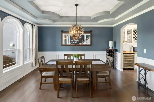 Dining room off to the left of entry.  Gleaming newly finished hardwood floors, coved ceilings and wainscoting give added luxury to this space!