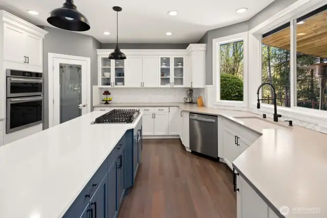 Quartz counter tops, custom tile backsplash, newly finished hardwoods, pantry and more in this GORGEOUS kitchen!