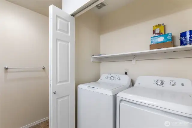 Double doors open to the Laundry Area with NEW GE washer & dryer and space above for storage.