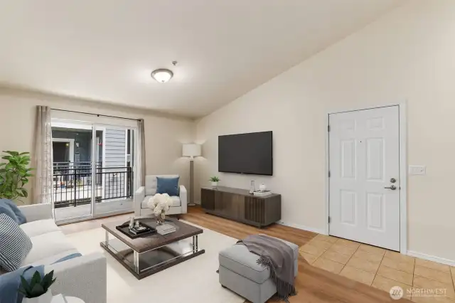 Wonderful natural light streams into the Great Room through the slider to the covered balcony. (virtual staging)