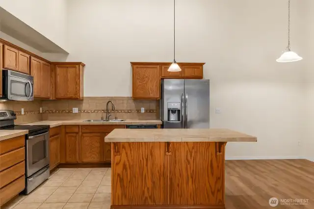 There's additional cabinet storage at the island and space for food prep and bar seating. Dining Area to the right...