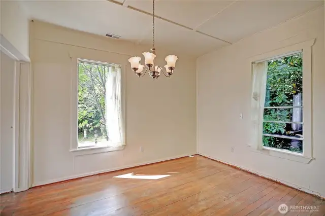 Dining room w/ original wood floors.