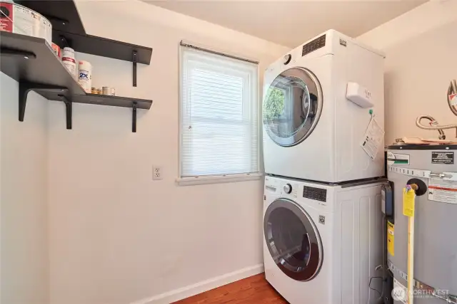 Stack washer and dryer in designated laundry room.
