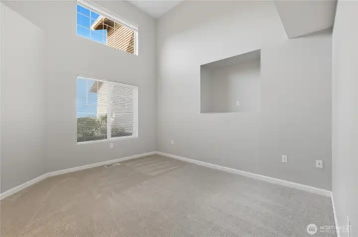 2nd bedroom with vaulted ceilings and shelving