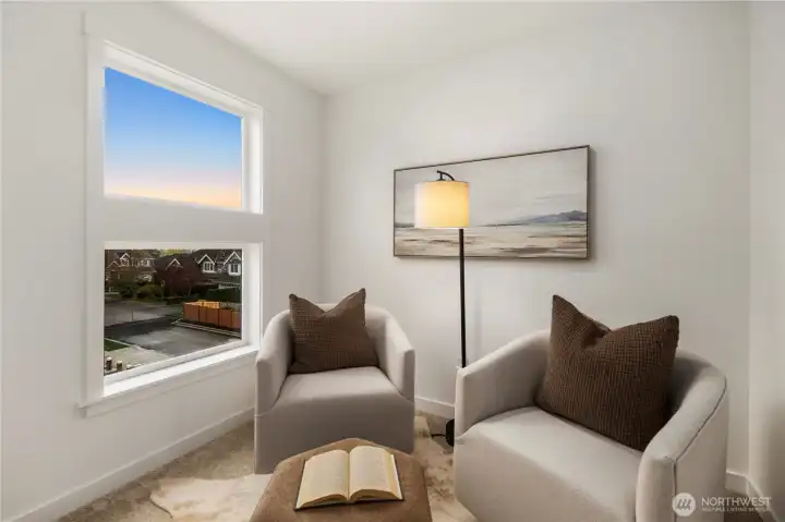 Primary Sitting Room: Private sitting room off the primary suite provides a cozy nook for reading, work, or relaxation. Bright windows and flexible space design make it a versatile extension of the suite.    Photos are from THIS model home at Foxmoore but are for visualization purposes only.