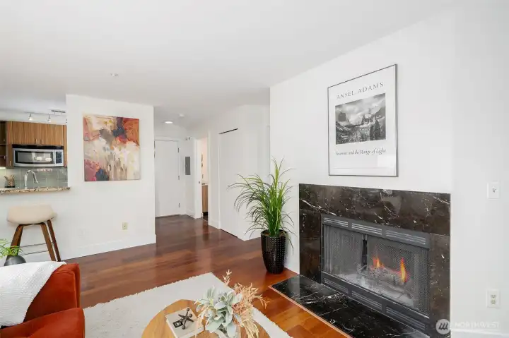 Fireplace creates instant ambiance while the open layout flows seamlessly from living to dining to kitchen.