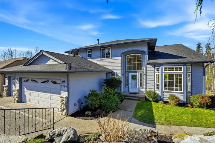 Follow the walkway along the right side of the home, past blueberry bushes and lush professional landscaping, to the backyard and private entrance to the daylight ADU.