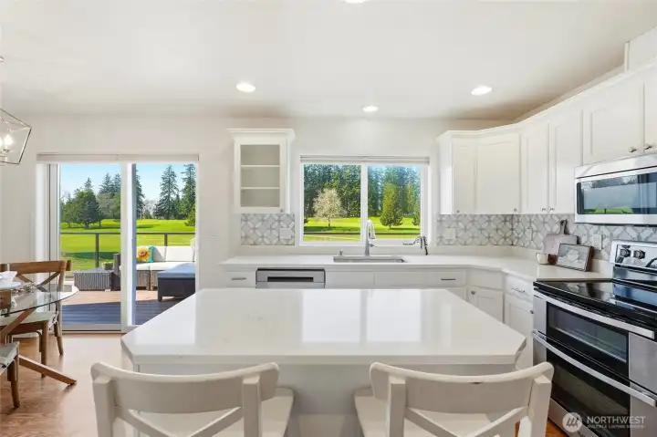 What catches your eye first, the quartz counters and marble tile backsplash, stainless appliances, or the sweeping green fairway views outsisde?