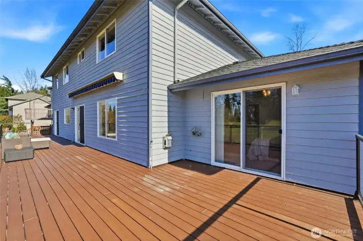 Private sliding door from the main-level primary suite opens directly to the expansive deck, creating an easy indoor-outdoor retreat.