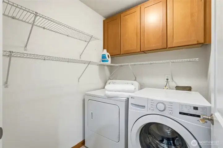 Dedicated laundry room with plenty of shelving to keep everything organized.