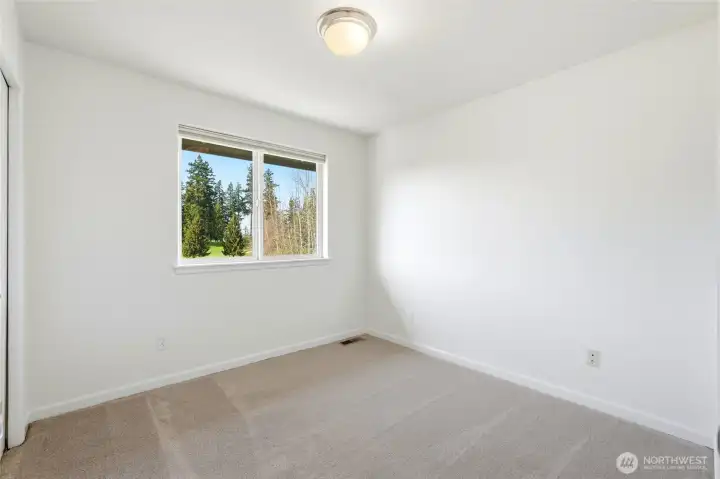 2nd quiet upper-level bedroom with relaxing views of the surrounding greenery.