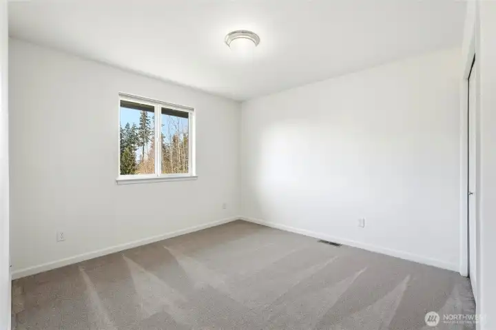 4th Light-filled upstairs bedroom with peaceful outlook toward the golf course.
