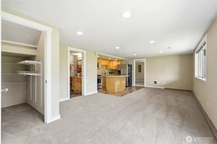 Spacious daylight basement ADU living area with full kitchen, open living space, and access to two bedrooms. Ideal for guests, extended living, or rental income.