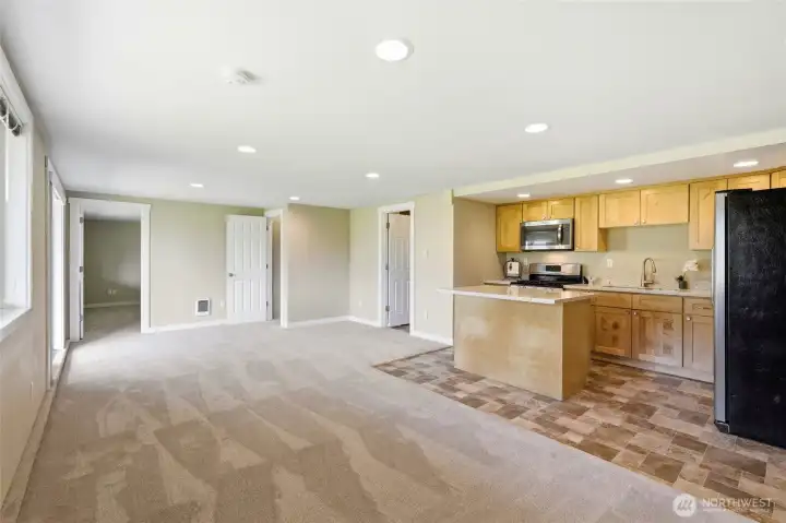 Spacious open-concept living area in the daylight basement ADU with full kitchen and generous room to relax or entertain.