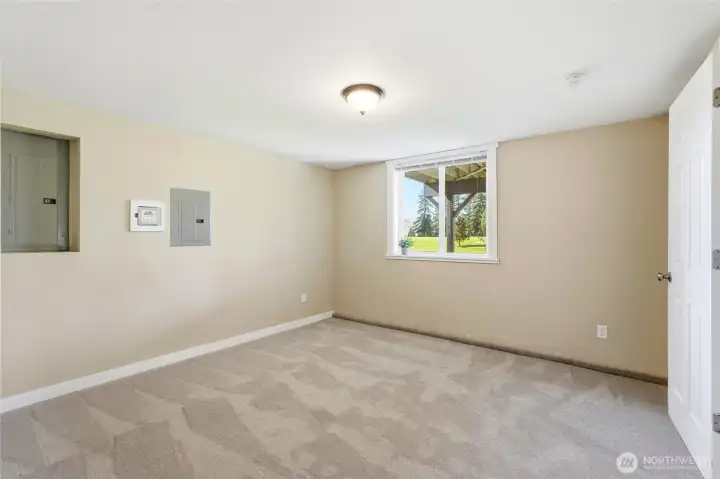 Second bedroom in the daylight basement ADU with peaceful golf course views and plenty of natural light.