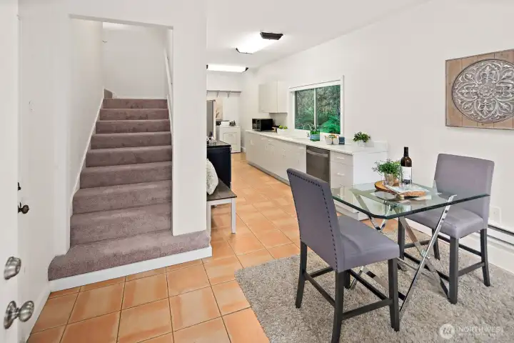 Welcoming entry with an eating nook and stairway to the upstairs bedroom.