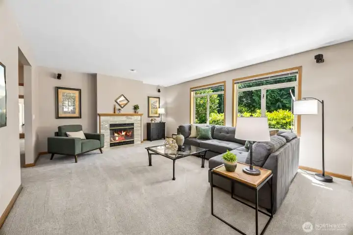 The family room features tall ceilings, a wood burning fireplace and is light & bright. The family room features tall ceilings, a wood burning fireplace and is light & bright.
