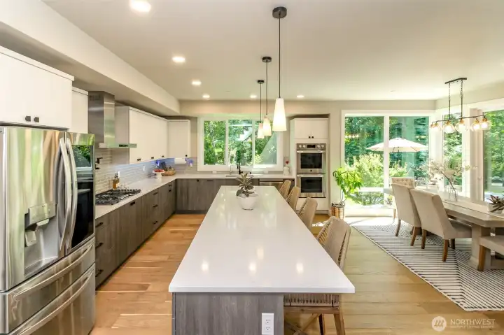 The kitchen is perfect for home life and entertaining with the huge granite slab kitchen island which seats four comfortably! Two panties as well!