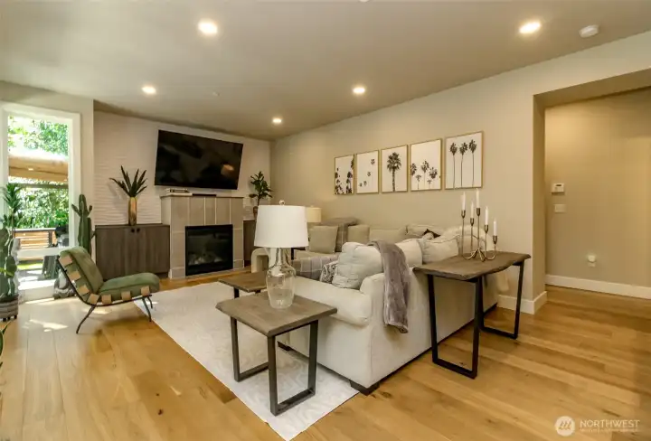 Built in cabinetry in the living room. To the far right is the hall to the bathroom, mudd room and 3 car garage Built in cabinetry in the living room. To the far right is the hall to the bathroom, mudd room and 3 car garage