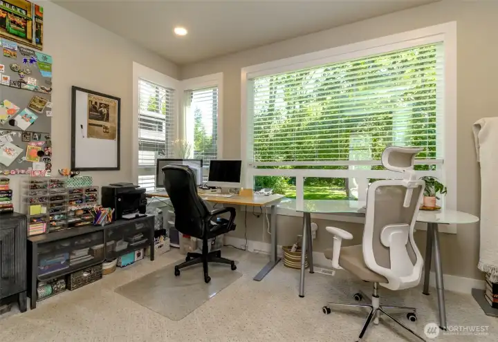 The main floor den has a scenic view to the private backyard and forest. The main floor den has a scenic view to the private backyard and forest.