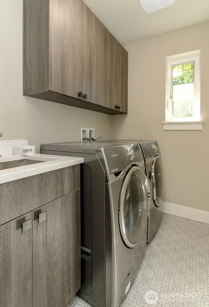 Full finished out laundry room with plenty of storage cabinets and utility sink. Washer and dryer do not stay. Full finished out laundry room with plenty of storage cabinets and utility sink. Washer and dryer do not stay.