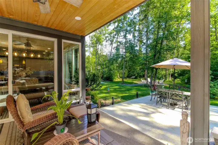 Cedar lined ceiling on back patio with lighting and fan.