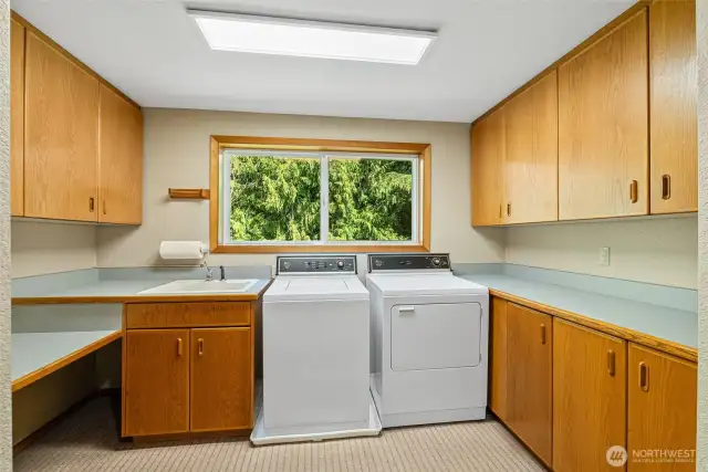 Main Laundry room with ample storage and craft space.