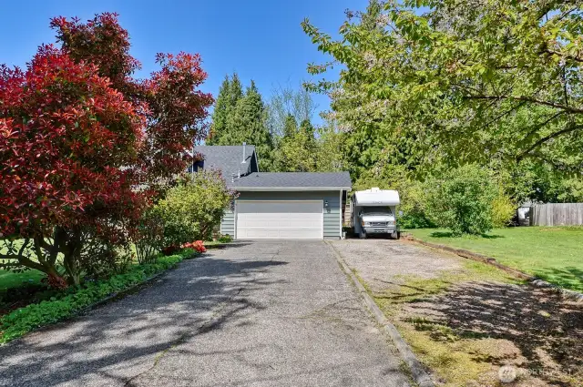Long driveway with extra parking pad.