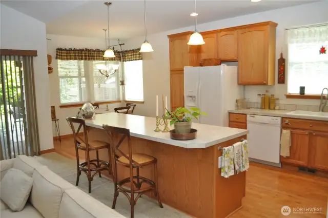 Open, light and bright kitchen has both a breakfast nook and bar seating.
