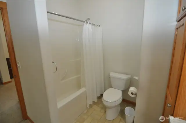 Main bathroom with tub and shower.