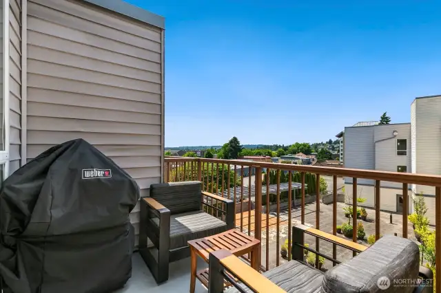 Private balcony space sits off main living room and overlooks 2nd outdoor patio space, also with BBQ area.