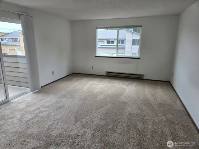 Master bedroom with slider leading out to patio.