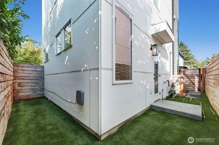 Turfed yard is low maintenance, and there is extra storage space here for bikes or paddleboards.