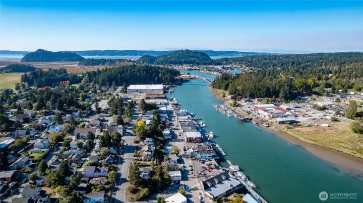 Picturesque La Conner, located along the Swinomish Channel, shown here with the famous Rainbow Bridge in the background.  La Conner boasts many fabulous eateries and charming shops.  Its marina and many docks make it the perfect gateway to the San Juan Islands, Puget Sound, fishing, crabbing, and boating.