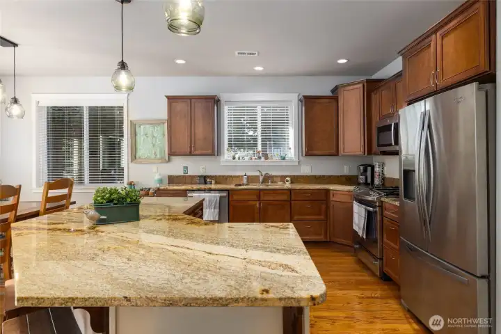 Solid slab granite counters enhance the warmth of the kitchen and provide plenty of space for all your culinary adventures.