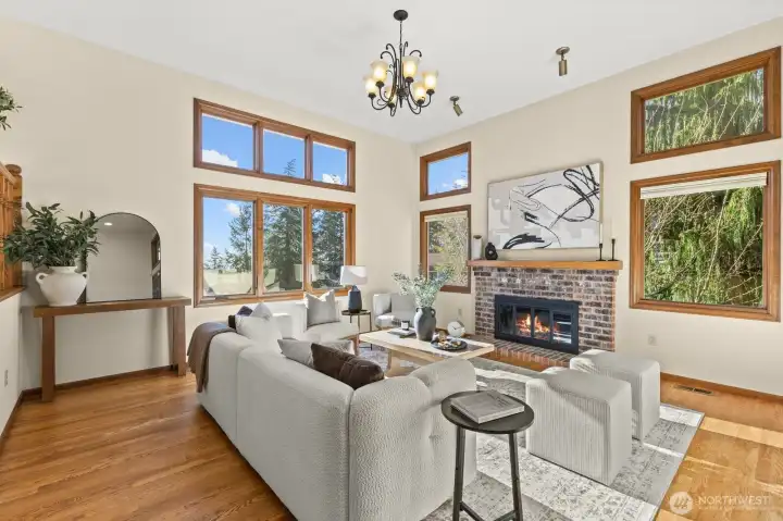 Entering on the main floor of the home and greeted by the formal living room. With soaring ceilings, a wood-burning fire-place and a wall of windows to take in the views- you will love spending time in this room!