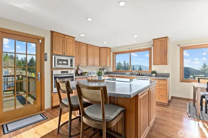 The heart of the home is a sunny, bright and cheerful kitchen with SS appliances, convenient counter seating, a kitchen dining area and handy access to one of the two entertainment sized decks.