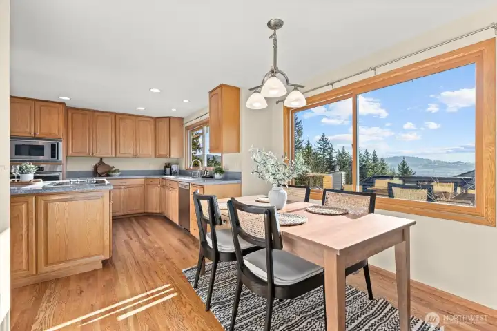 Kitchen dining area flows effortlessly into the formal dining room. Look at those views!