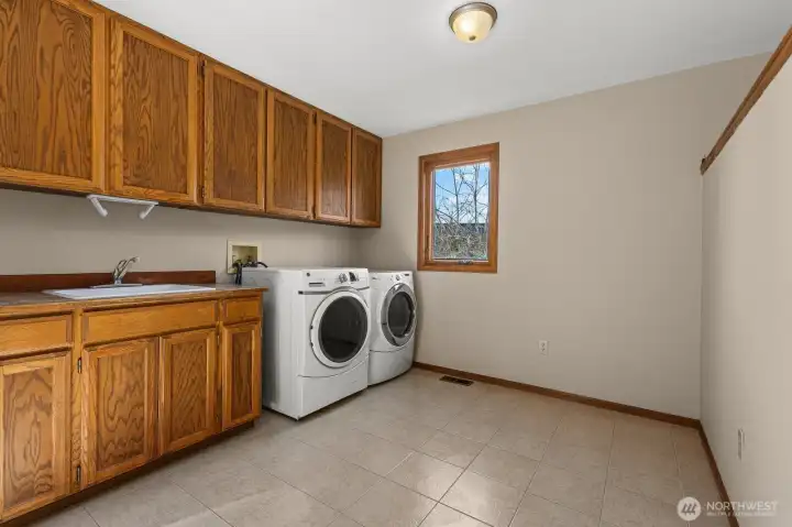 Massive laundry room with a handy full-size laundry sink.