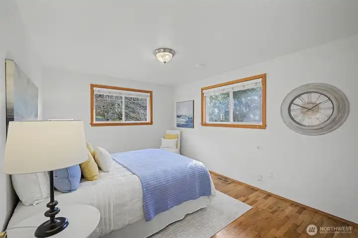 Second guest bedroom with hardwood floors and abundant natural light.