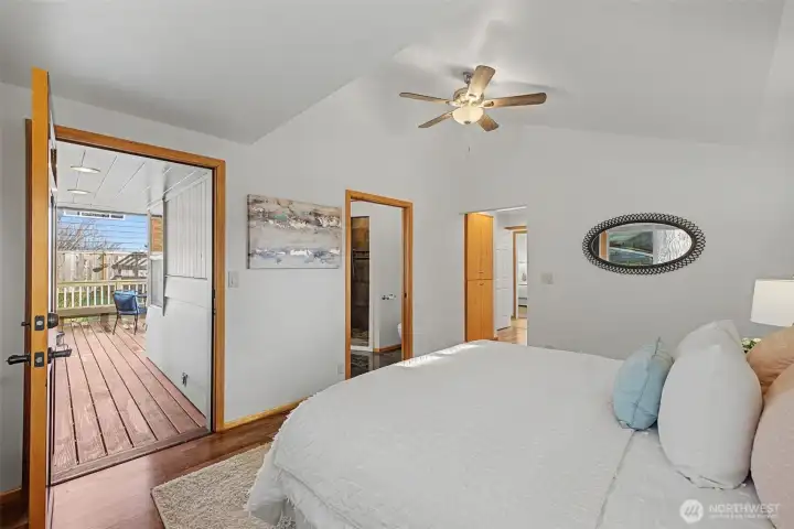 Primary suite with laminate flooring, private access to the covered porch, and direct entry to the ensuite bath and walk-in closet, offering a comfortable and well-designed owner’s retreat.