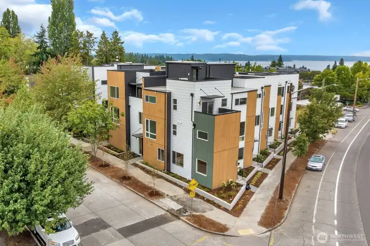 Light filled corner unit.  Parking is not a problem here as 5 of the 6 units come with a parking spot on the property including 3 with garages, all with EV hookup ready.  And friends and family can visit anytime as street parking has always been available.