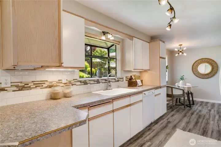 Kitchen space is large with separate dining nook. Kitchen sink has plant window in front of the kitchen sink overlooking the backyard. Kitchen space is large with separate dining nook. Kitchen sink has plant window in front of the kitchen sink overlooking the backyard.
