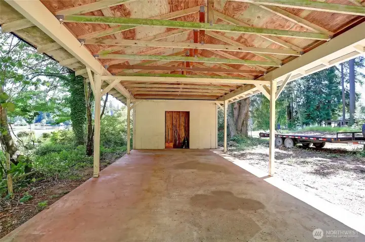 Large detached carport for parking your car or storing your water toys.