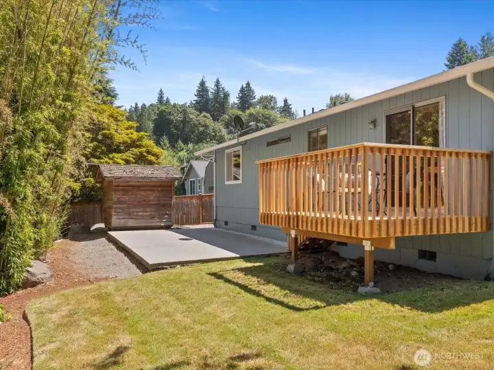 The outbuilding provides space for lawn equipment and storage.